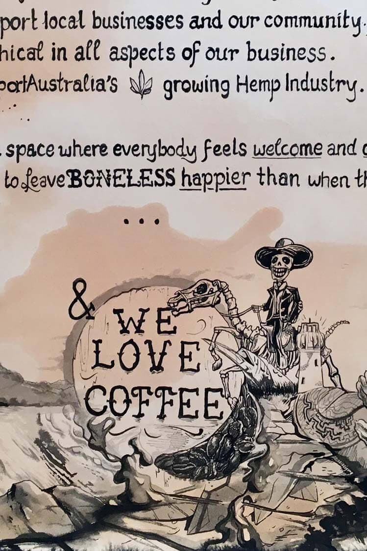 A sepia ink poster for Boneless: hand-lettered values about local business and community above a “We love coffee” roundel and a sombrero-wearing skeleton.