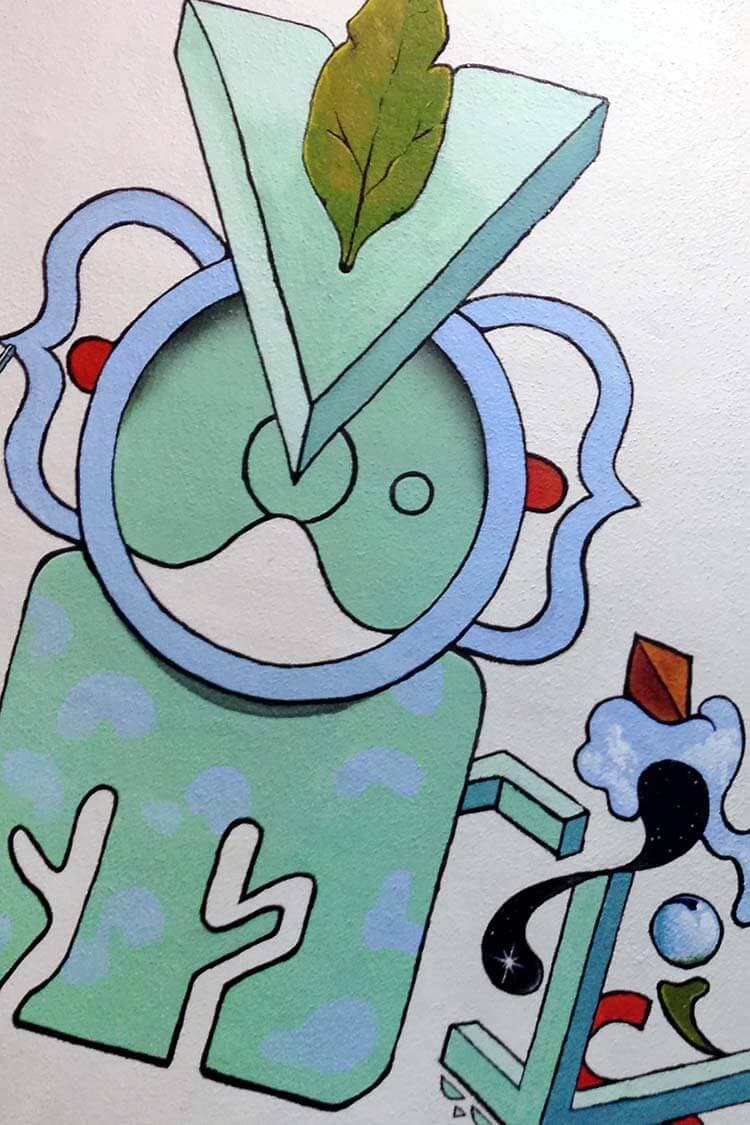 A bathroom mural of flat mint, sky-blue and red shapes outlined in black, a cartoon-like abstraction crowned with a single painted leaf.